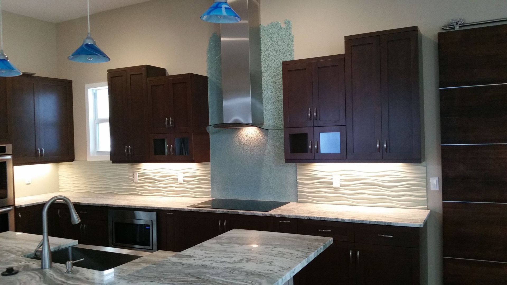 A kitchen with stainless steel appliances and granite counter tops.
