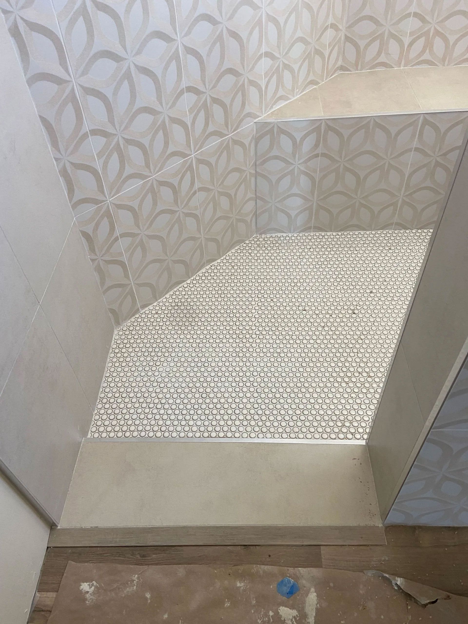 A bathroom with a tiled floor and stairs.