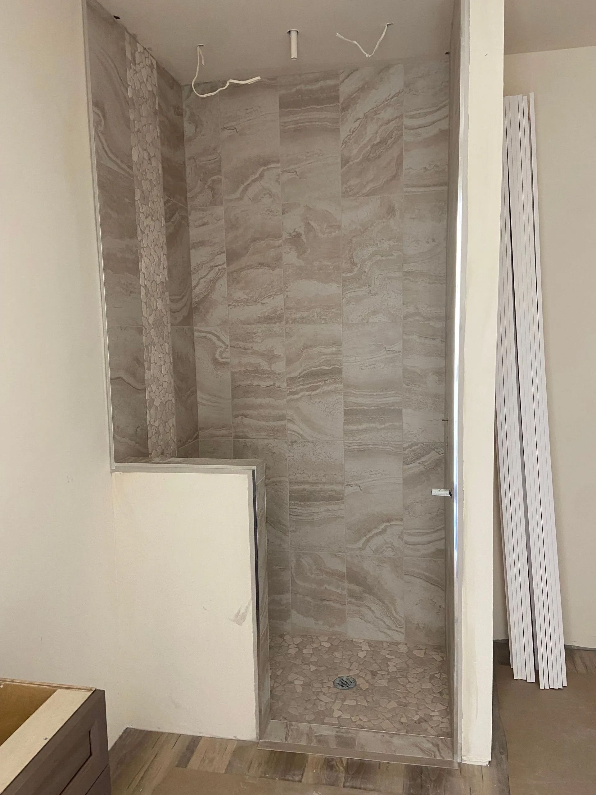 A bathroom with a walk in shower and a bathtub.