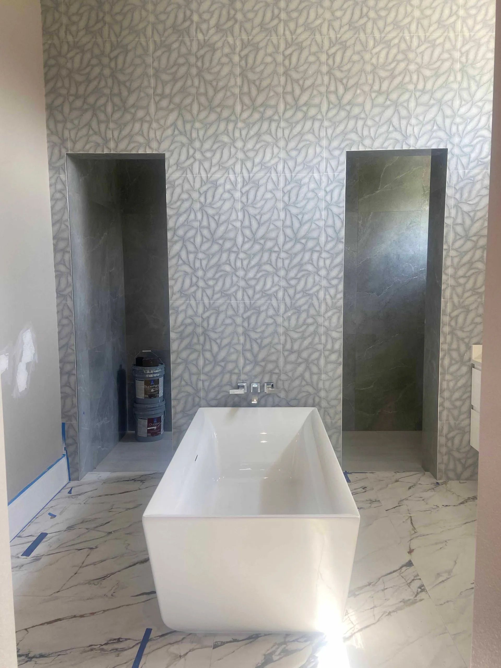 There is a bathtub in the middle of the bathroom.