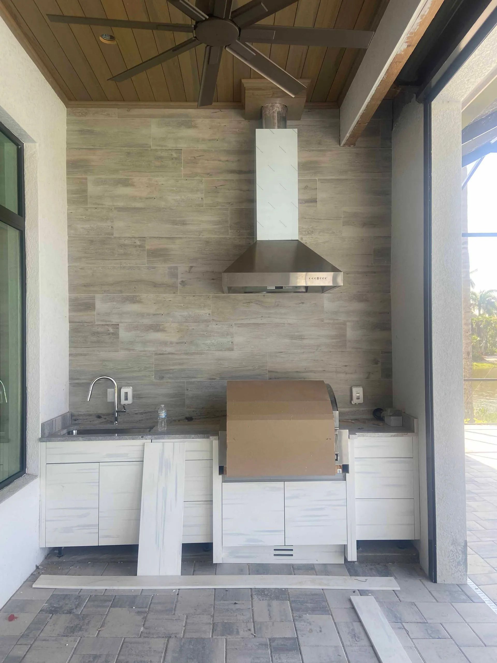 A kitchen with a grill and a ceiling fan.