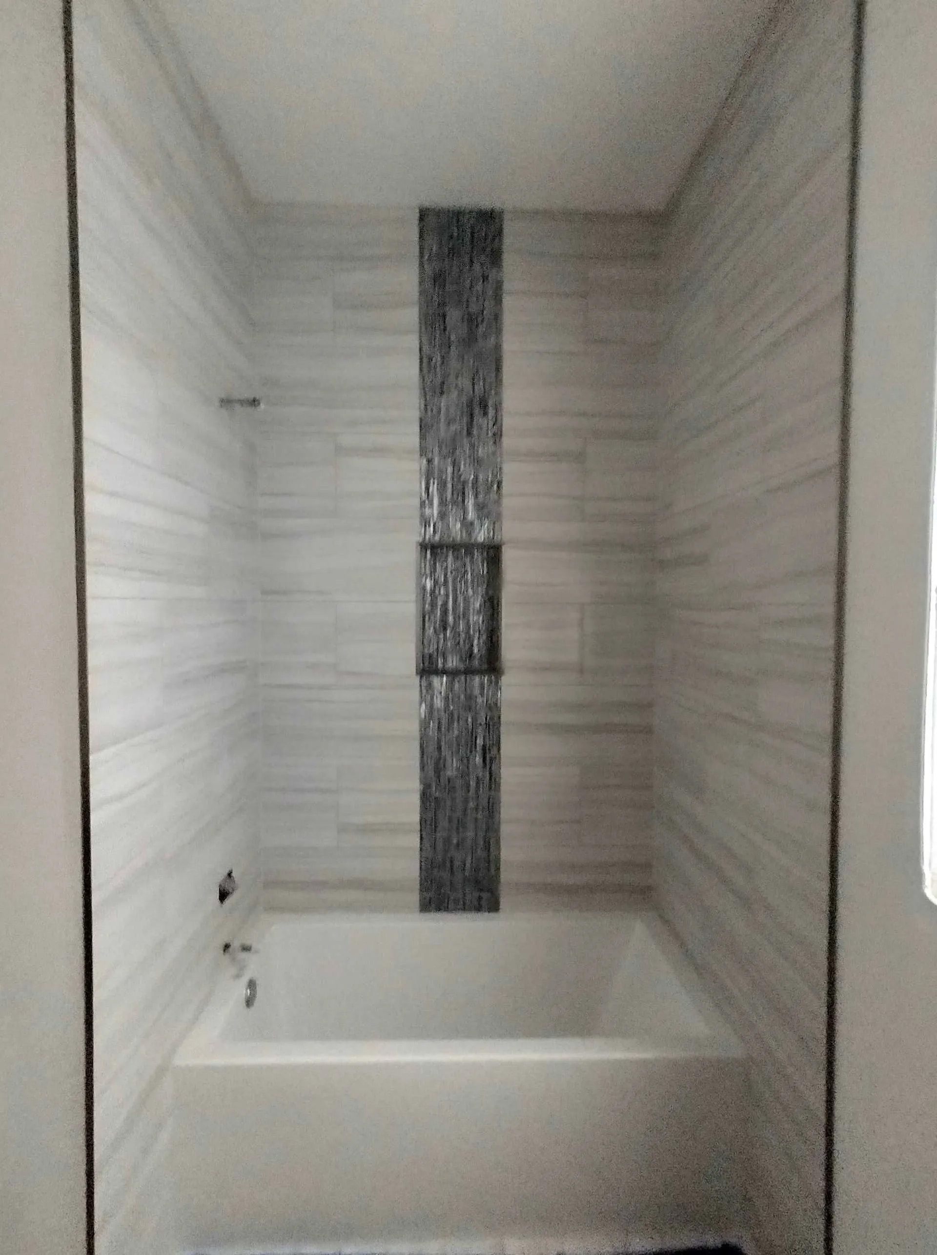 A bathroom with a tub and a shower.