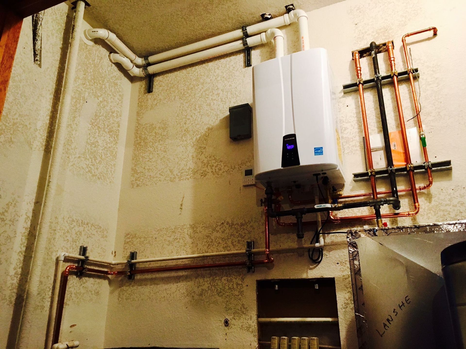 A white water heater with a blue x on it