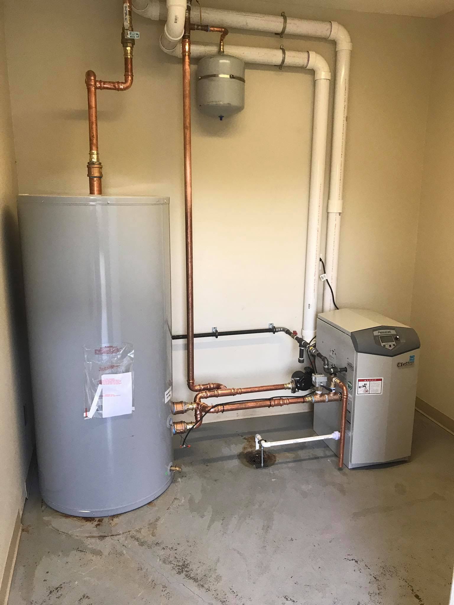 A room with a water heater and copper pipes
