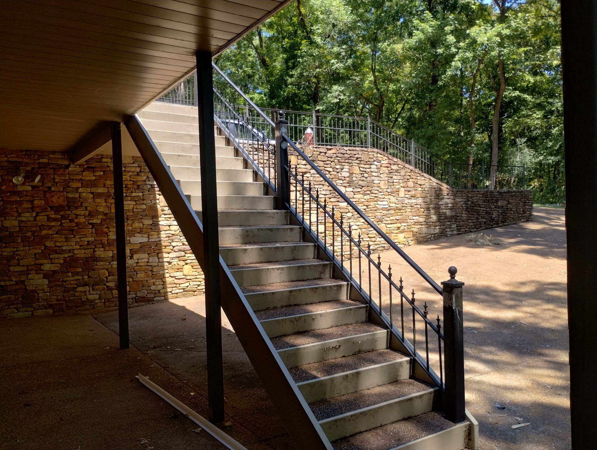 A set of stairs leading up to a stone wall.