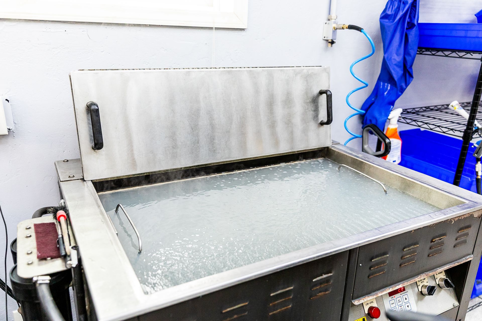 A stainless steel tray filled with water in a room.