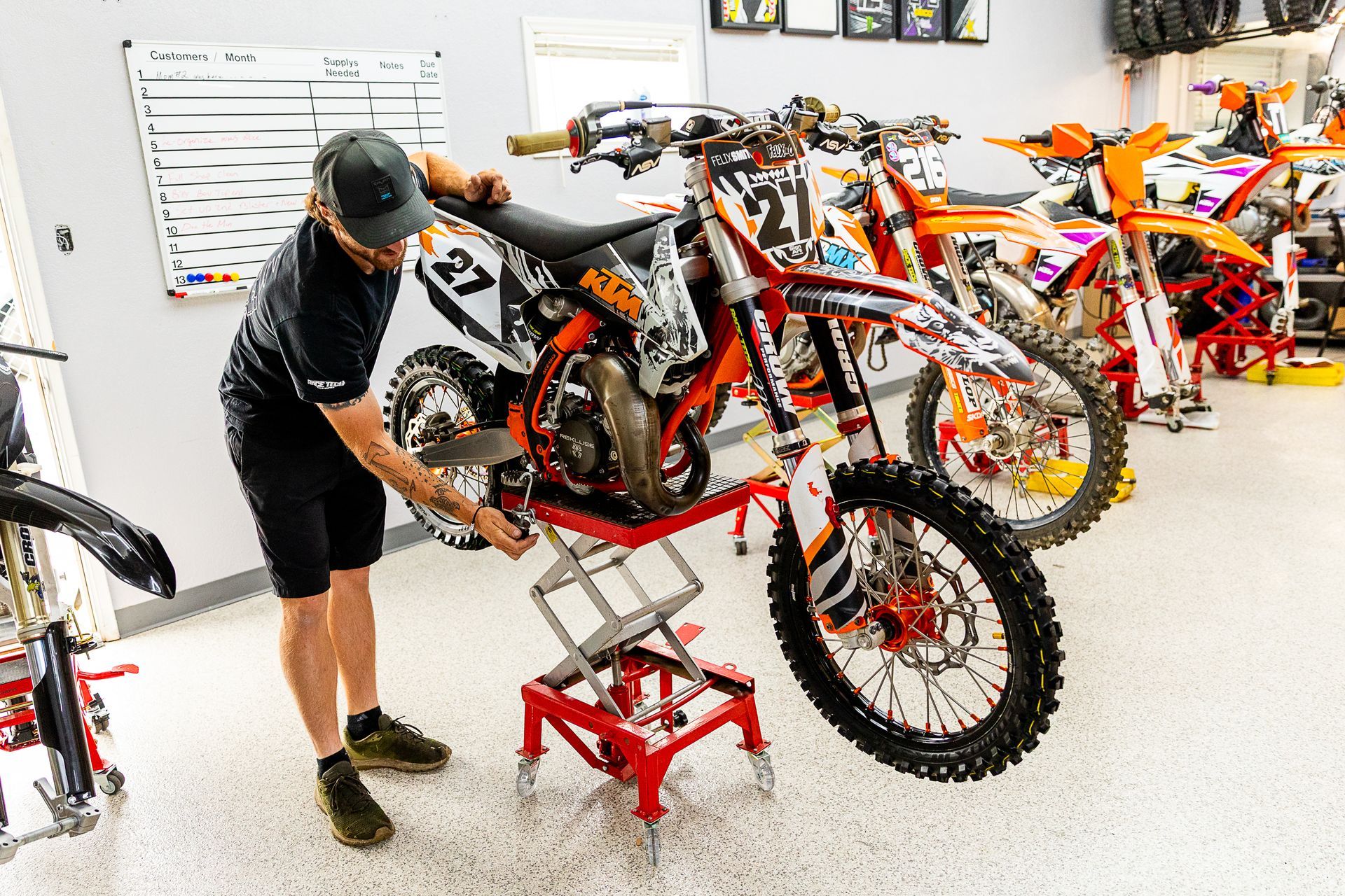 A motorcycle is being worked on in a garage.