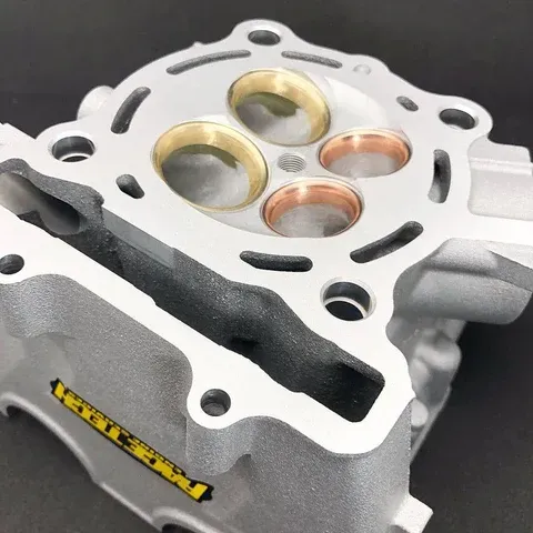 A close up of a cylinder head with a yellow ruler on it