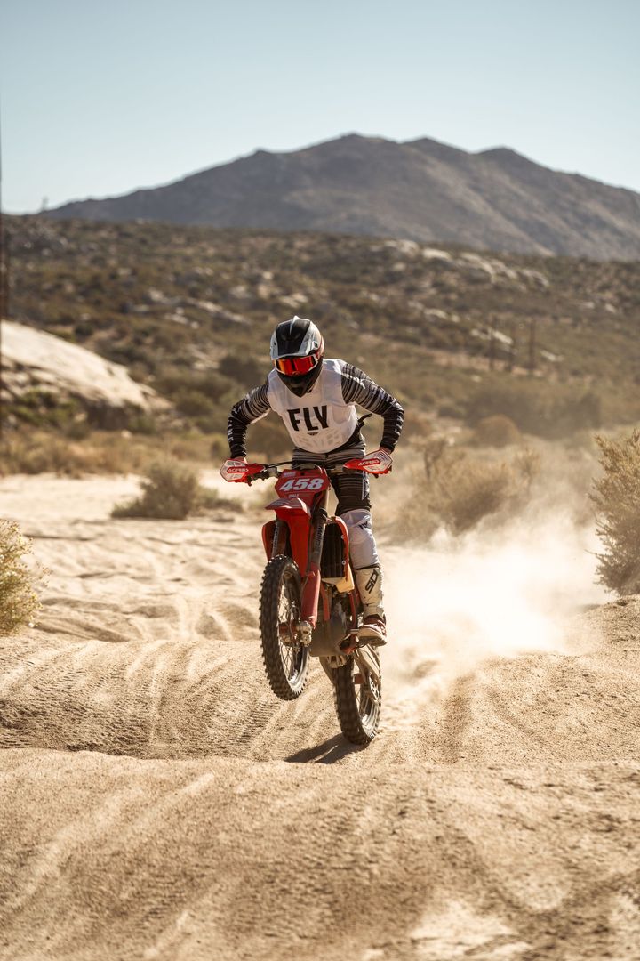 A person is riding a motorcycle on a track.