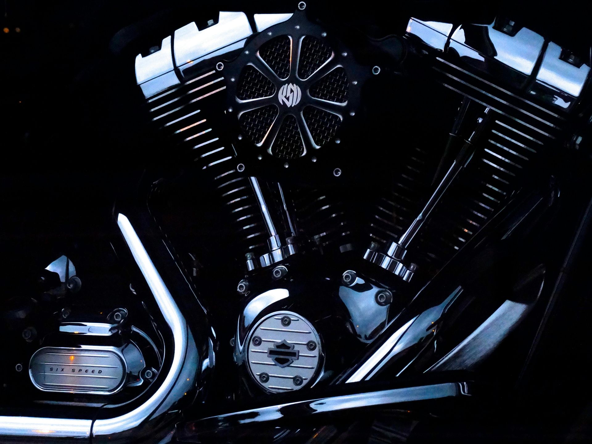 A black motorcycle is parked on the side of a road.