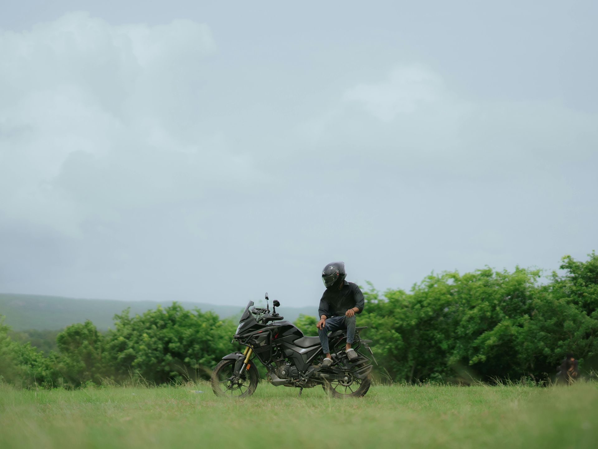 A group of people are riding motorcycles in the rain.