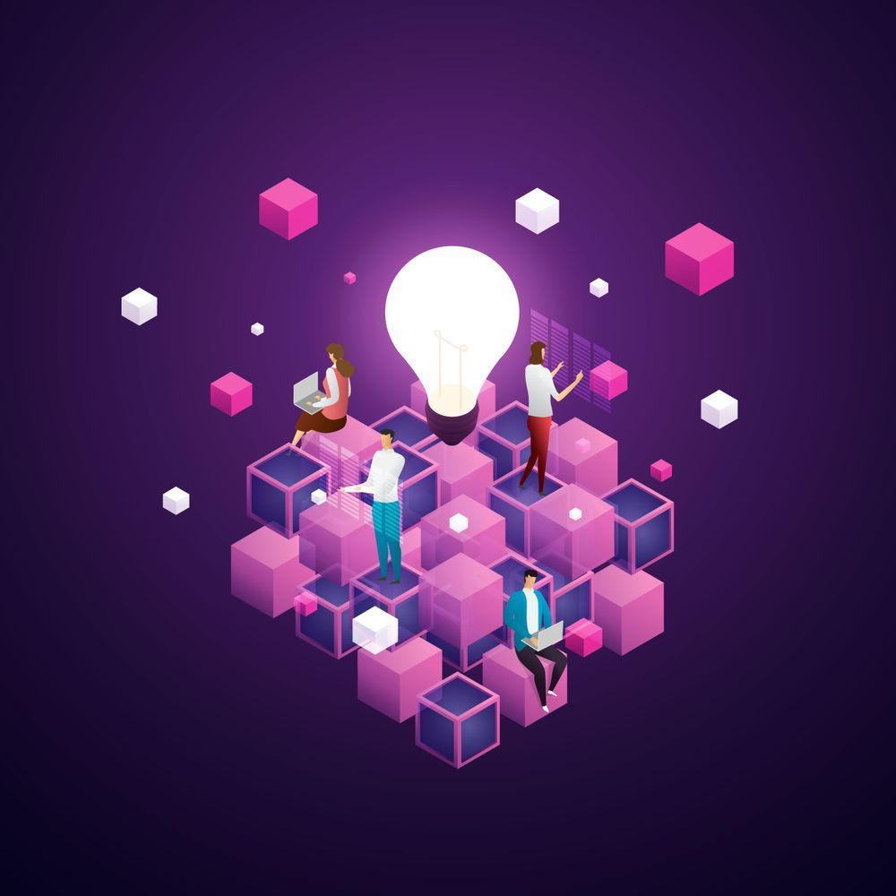 A group of people are standing around a light bulb surrounded by pink cubes.