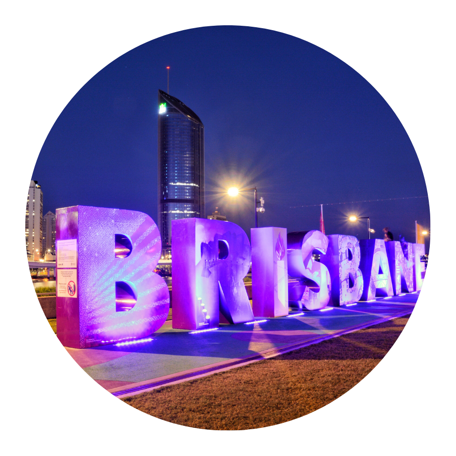 A sign for brisbane is lit up at night