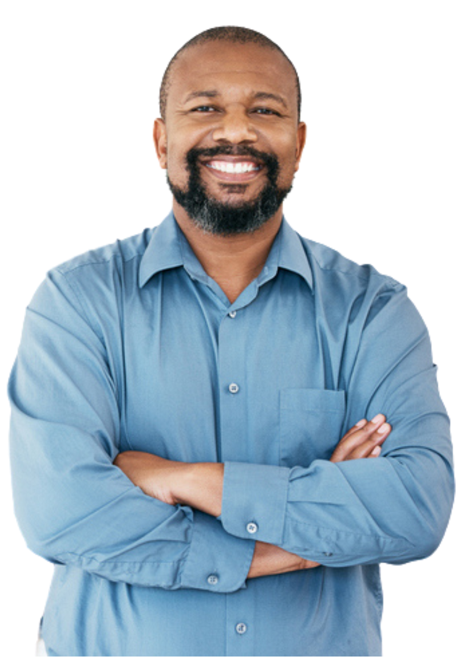 A man in a blue shirt is smiling with his arms crossed