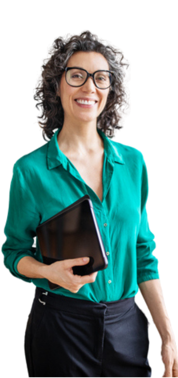 A woman in a green shirt is holding a laptop and smiling.