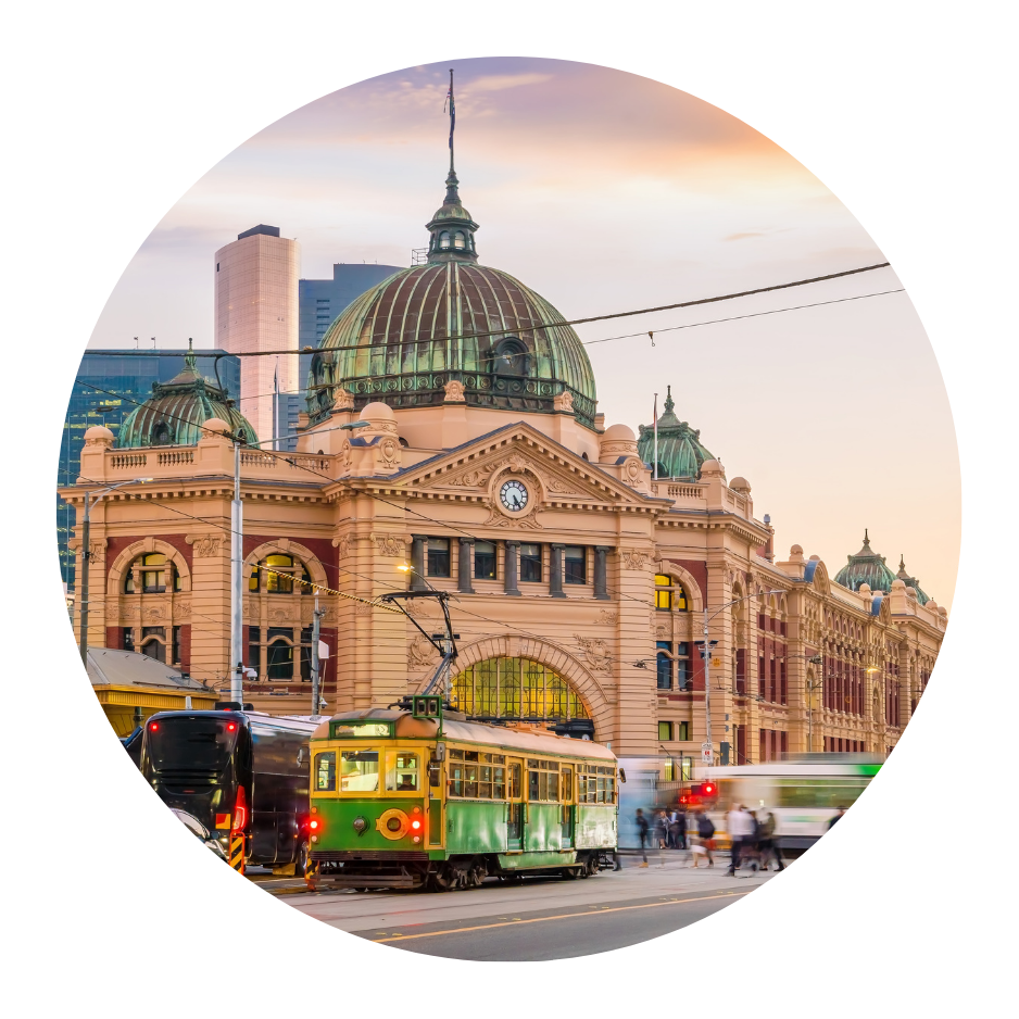 A trolley is parked in front of a large building with a dome.