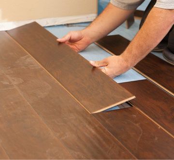 Hardwood Installation — Man Installing New Laminate Wood Flooring in Sevierville, TN