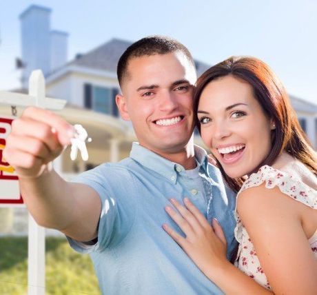 Military Couple in Front of a House — Title Services in Anoka, MN