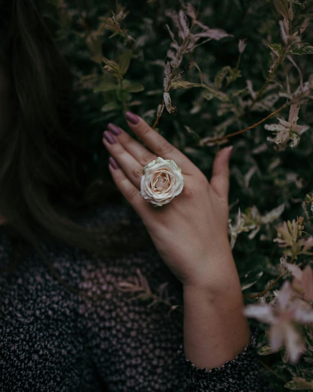 Hands giving a back massage; person lying face down, covered in oil, on a massage table.