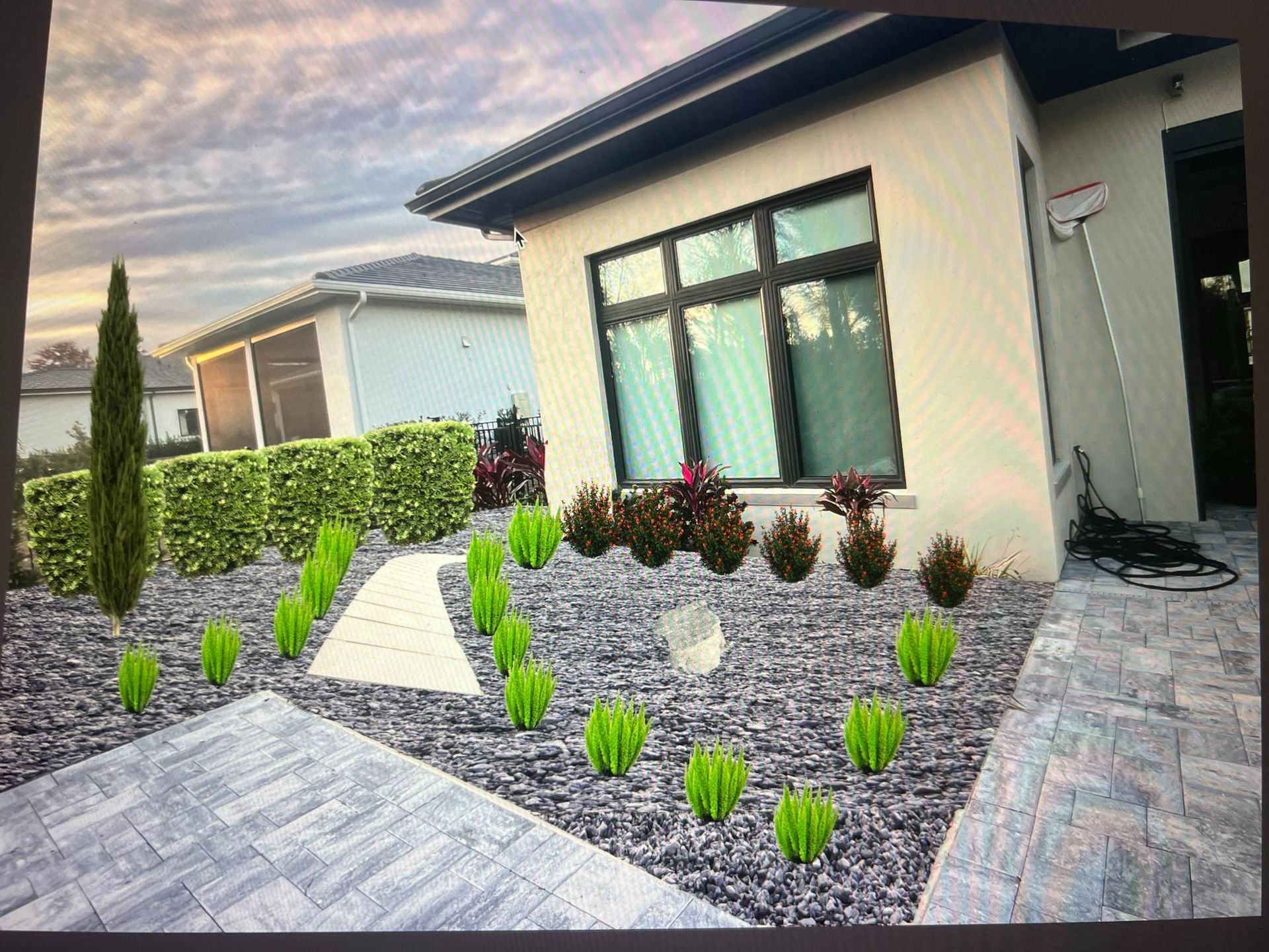 Landscaped yard with pathway, plants, and modern house.