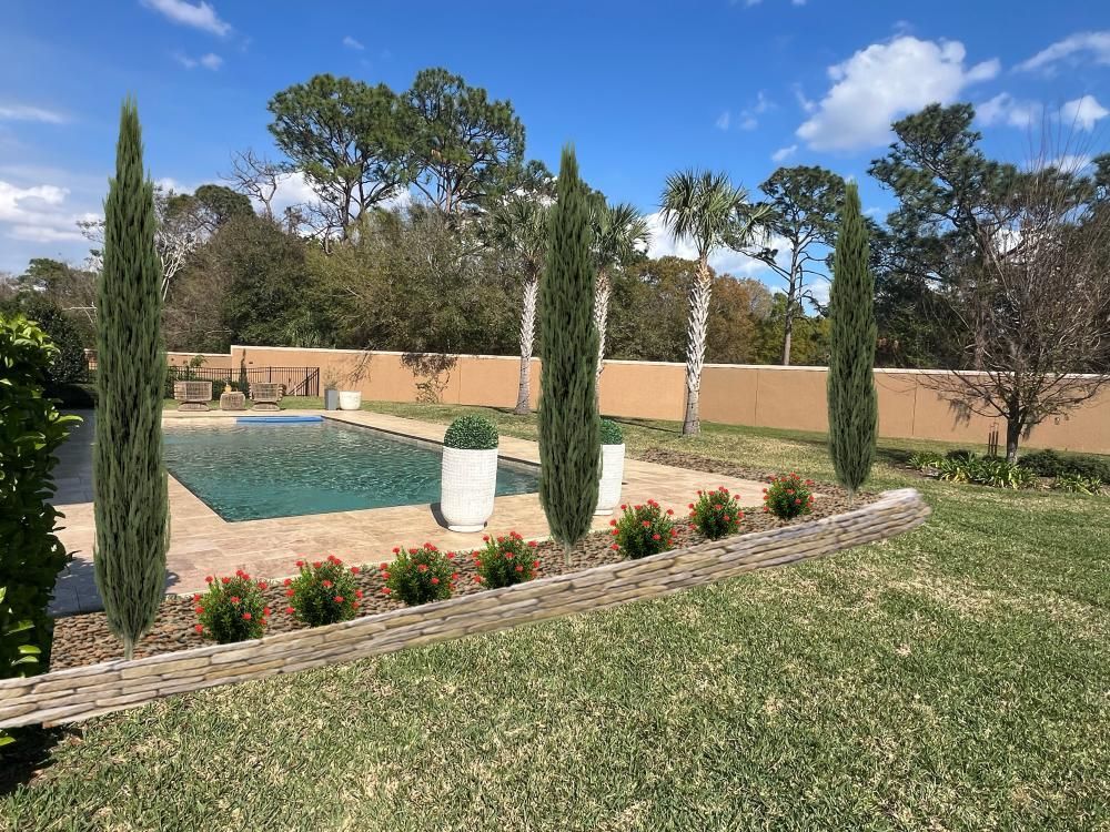 Poolside scene: Cypress trees frame a pool, lawn in foreground, neutral-colored wall in background under a blue sky.
