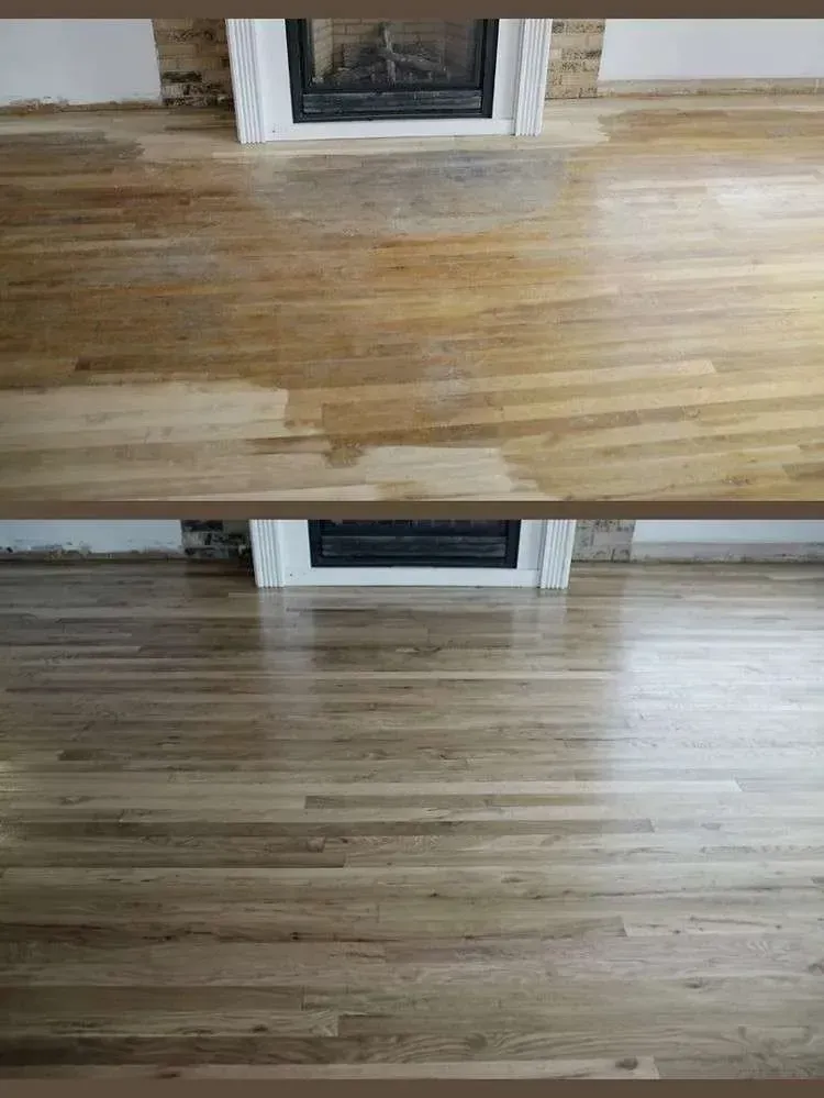 A living room with a wooden floor and a fireplace.