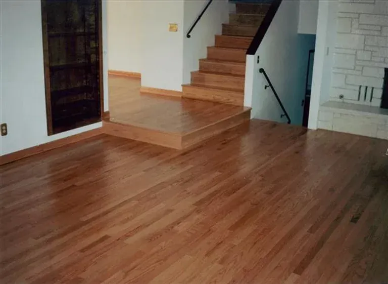 A living room with hardwood floors and stairs