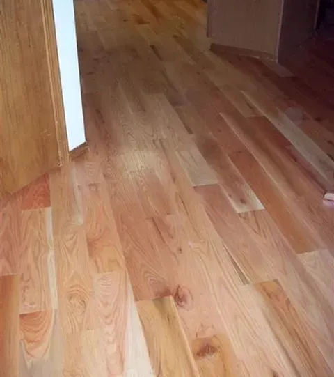 A close up of a wooden floor in a room.