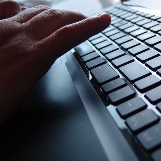 A close up of a person typing on a keyboard