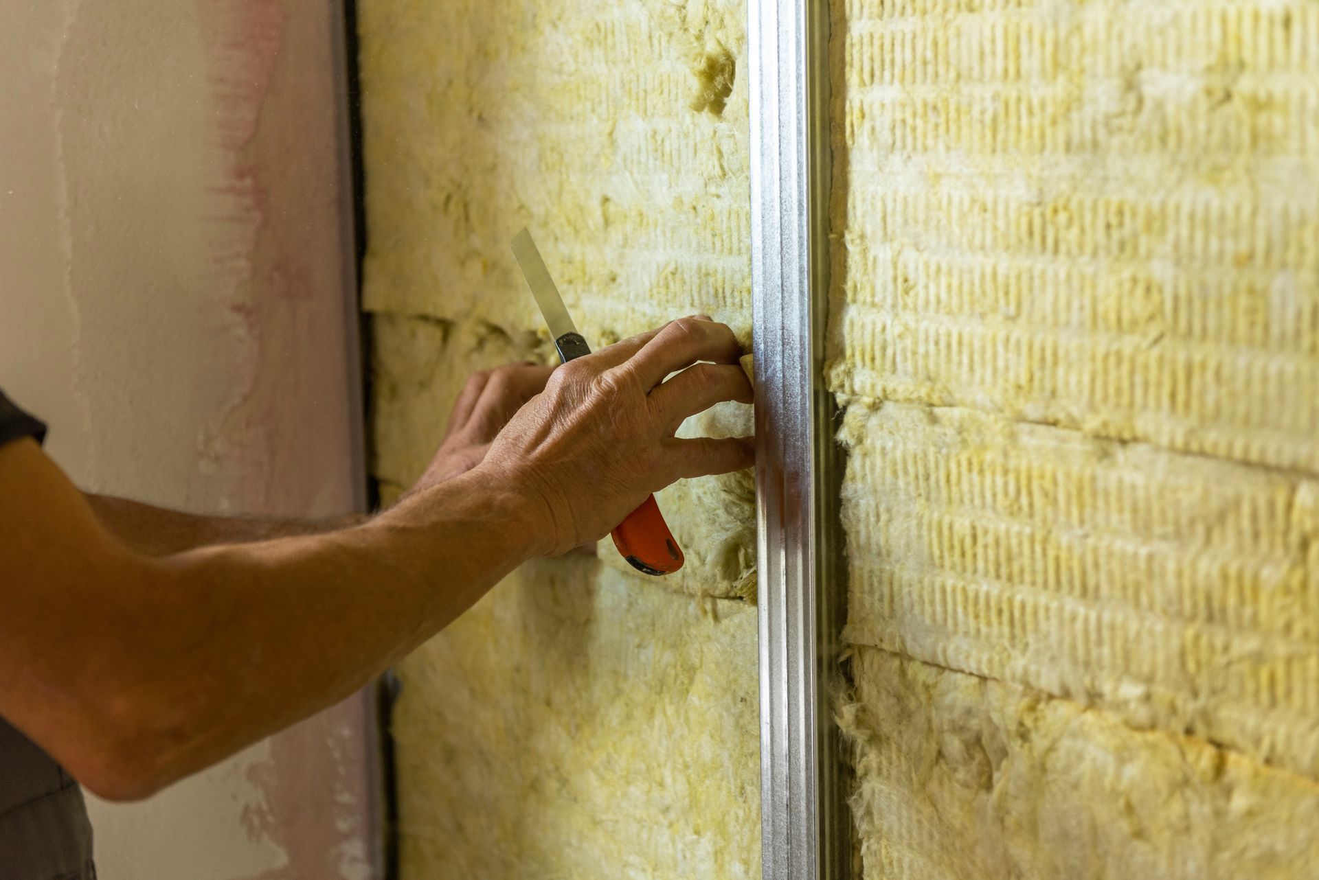 A Person Is Working on a Wall with a Knife | East Gosford, NSW | Clark’s Insulations