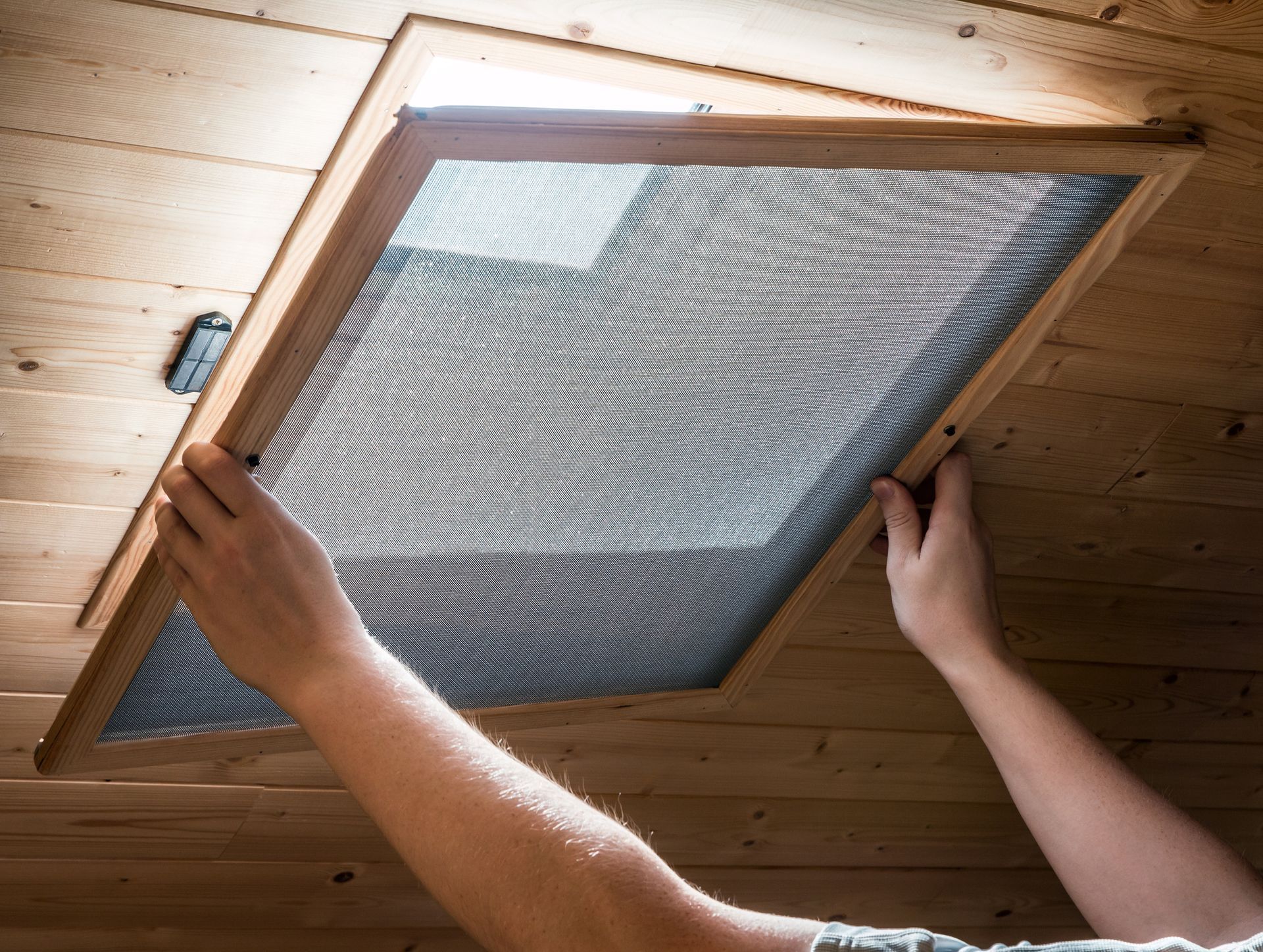 A Person Is Opening a Window with a Screen on It | East Gosford, NSW | Clark’s Insulations