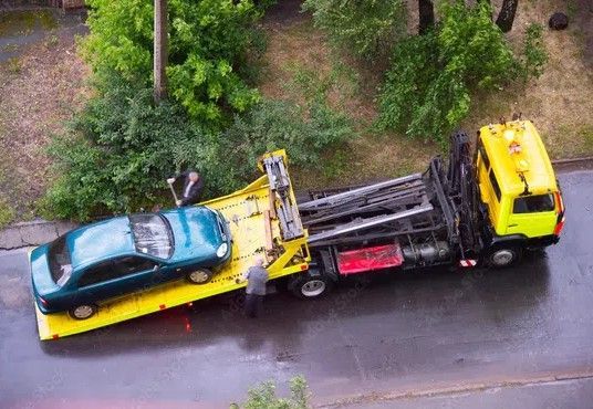 overhead view of car on the back flatbed of a tox truck