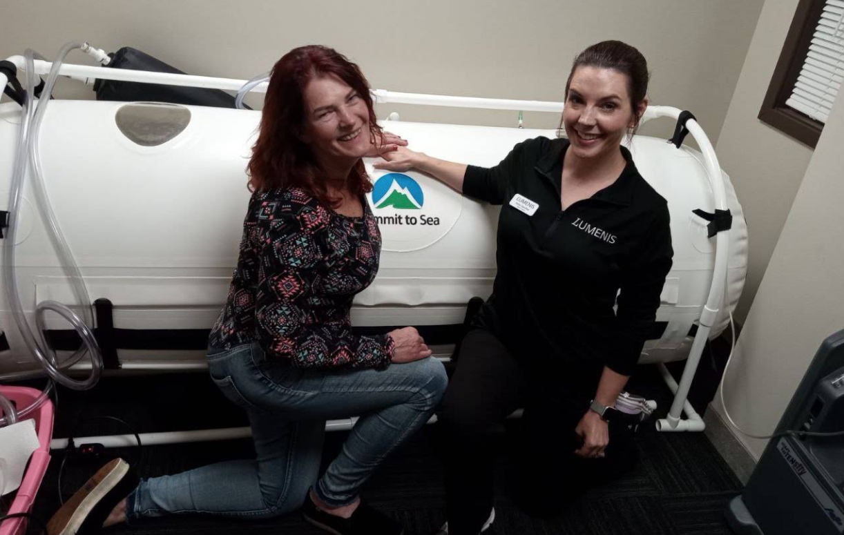 Woman receiving laser hair removal treatment on her legs in a medical setting.