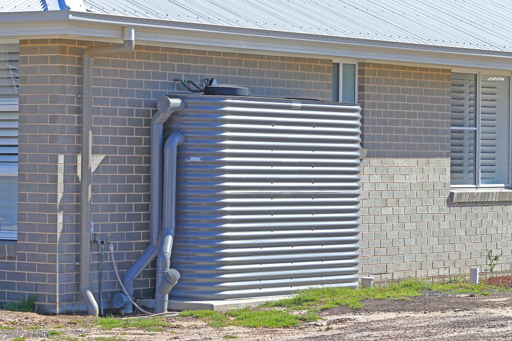 A rainwater tank installed next to a house in NSW