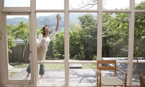 Woman Cleaning Window — Schenectady, NY — Paige's Janitorial Cleaning Service and Floor Care