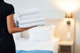 Woman Carrying Towels — Schenectady, NY — Paige's Janitorial Cleaning Service and Floor Care