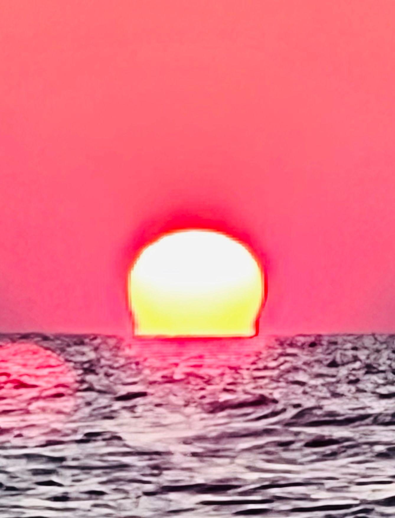 The sun is setting over the ocean.