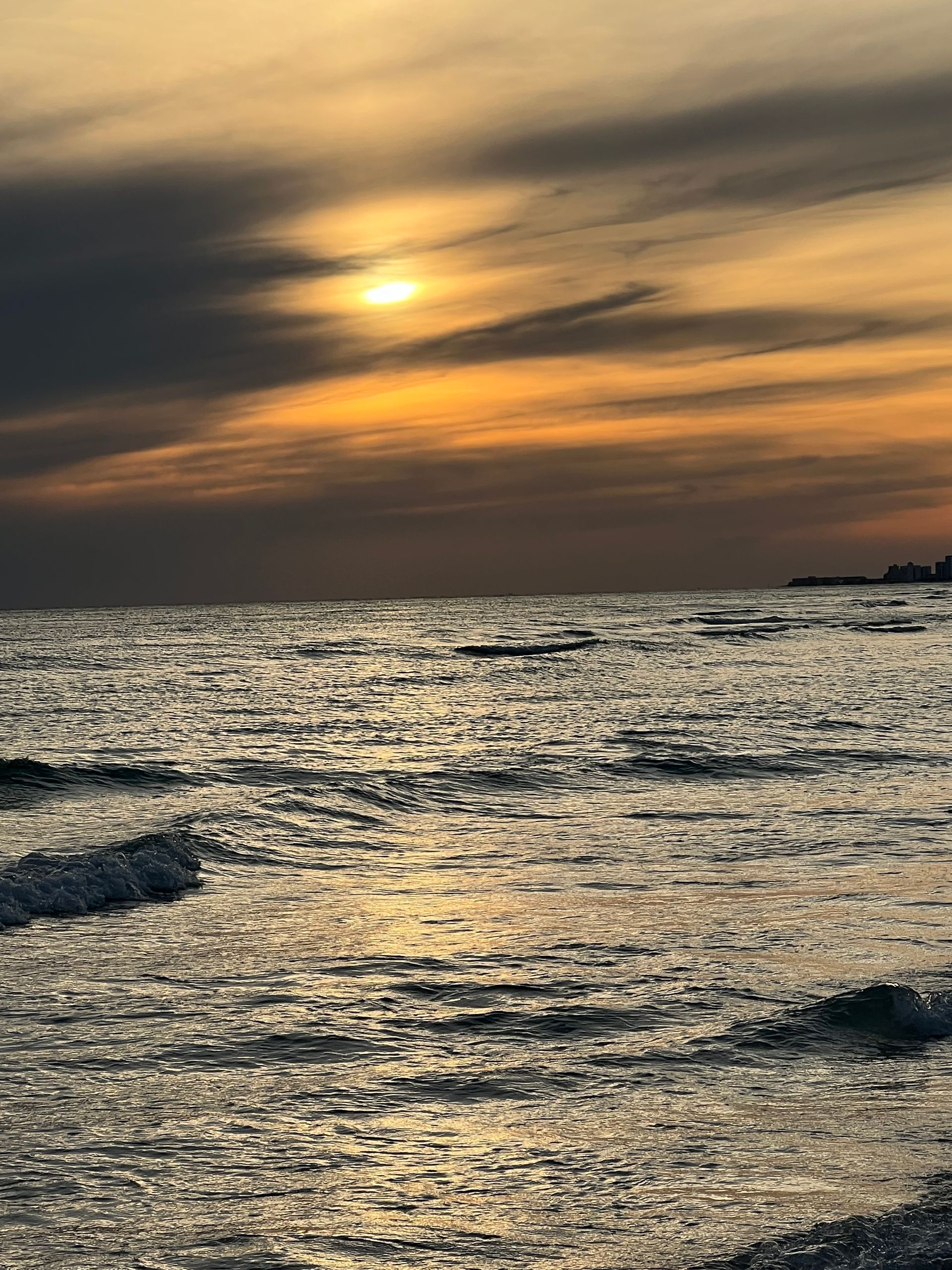 The sun is setting over the ocean.