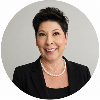 a woman wearing a pearl necklace and a black jacket is smiling .