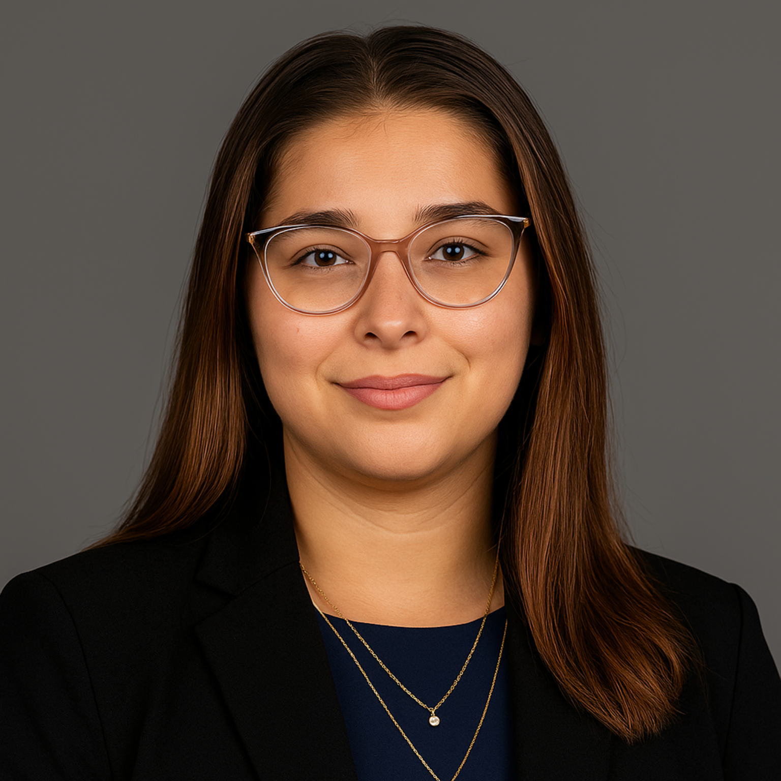 a woman wearing a pearl necklace and a black jacket is smiling.