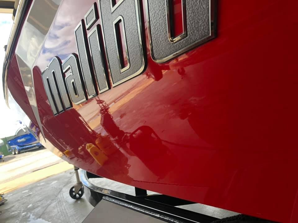 A red boat with the word malibu on it