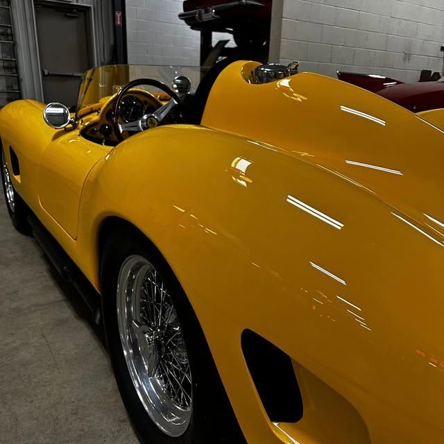 A white atv is parked on the side of a dirt road.