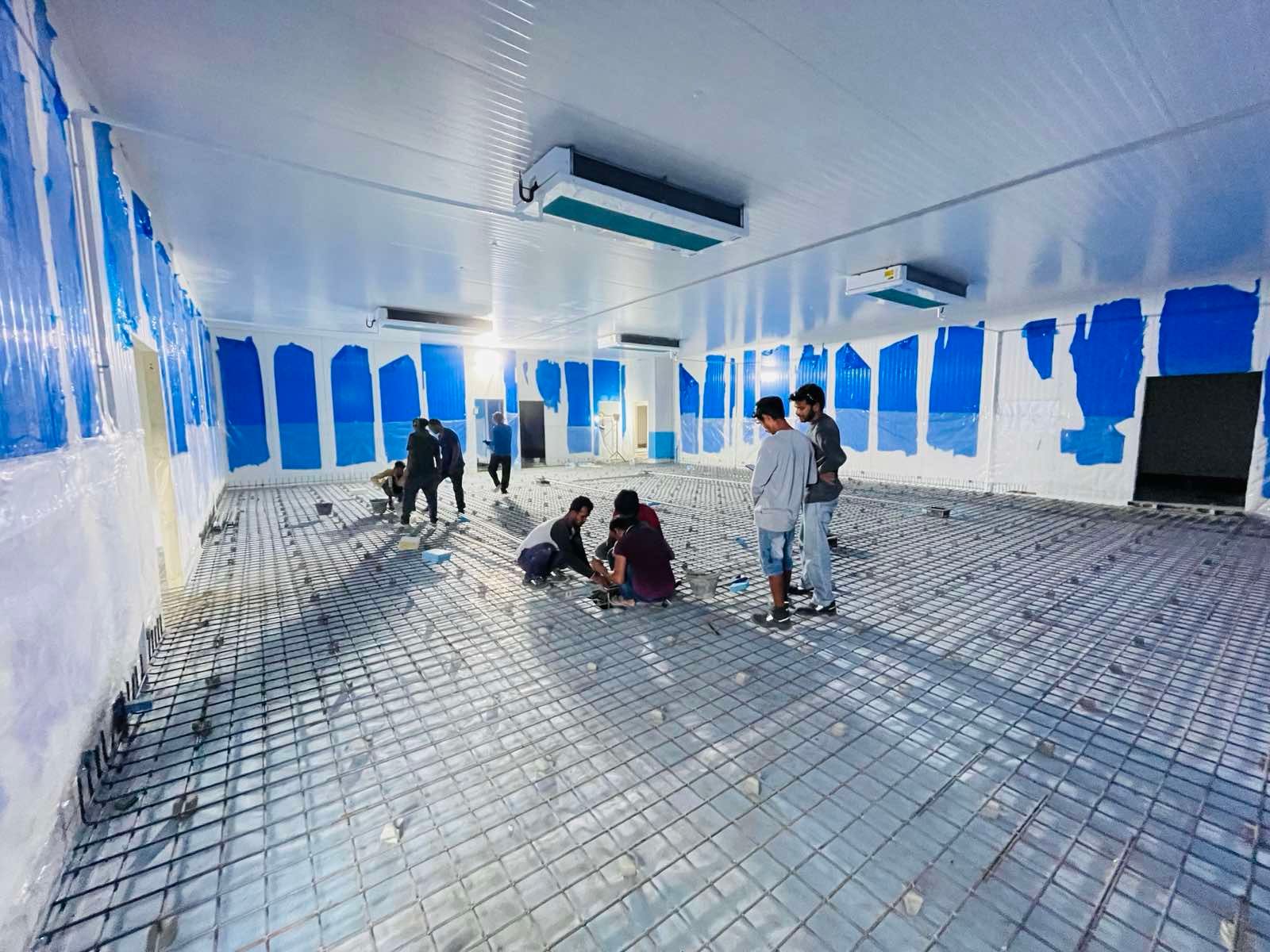 A group of people are working on the floor of a building.