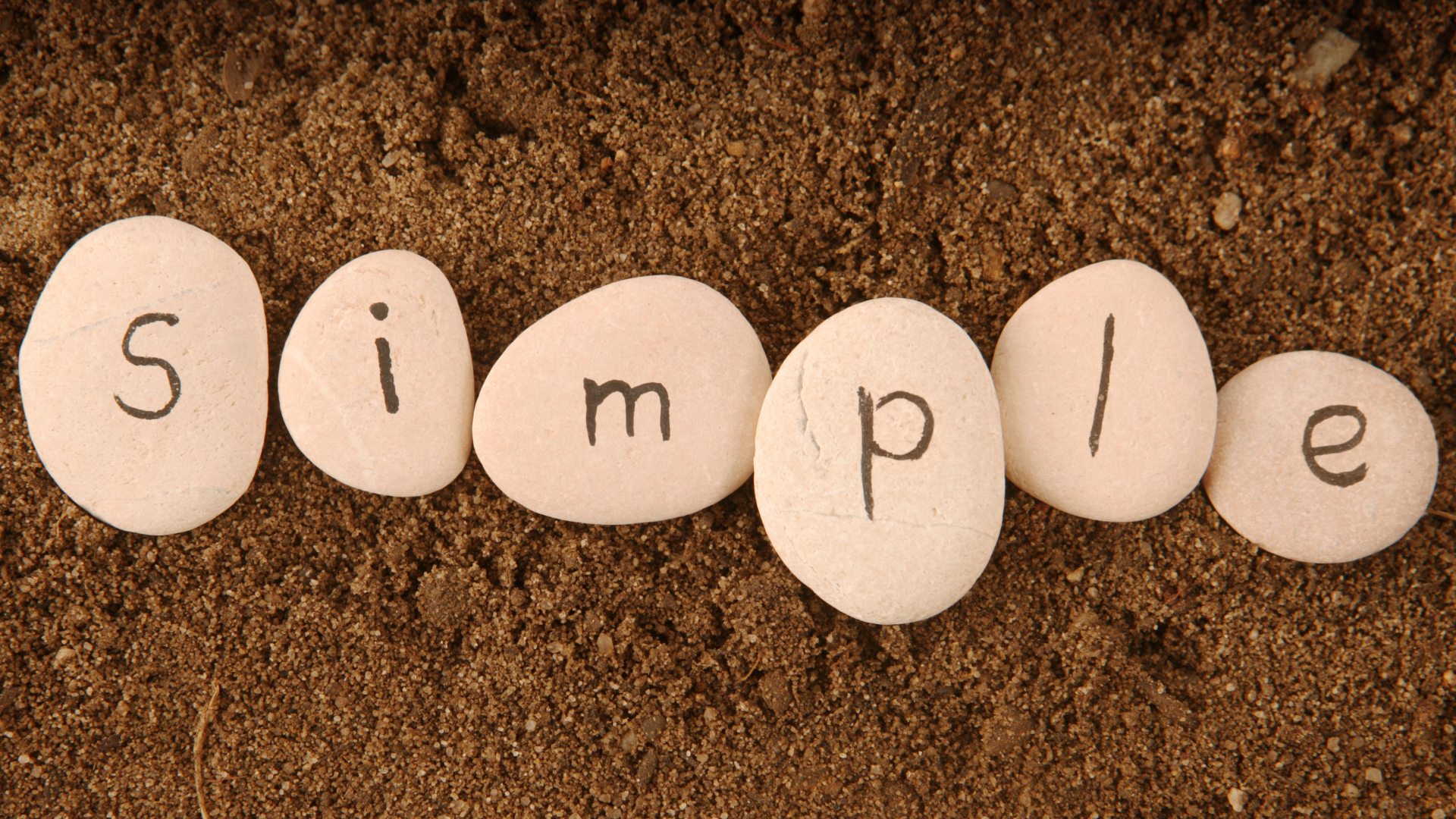 The word simple is written on a pile of rocks