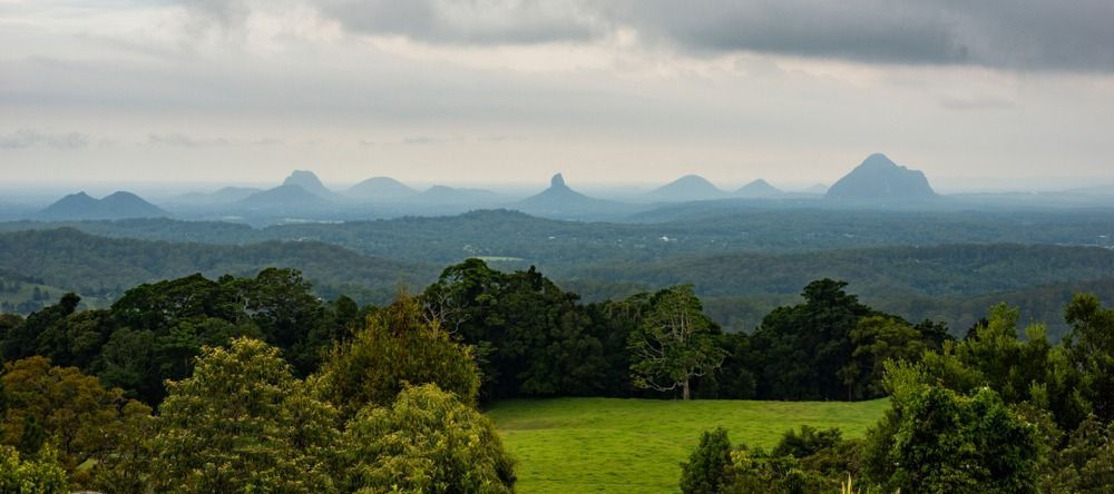 Distant Mountains Rise Above A Green Valley — Superstretch300 Limousines In Sunshine Coast, QLD