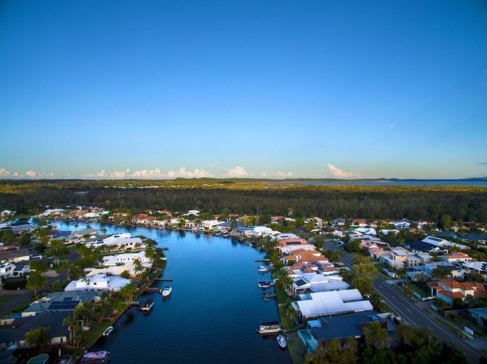 Waterway Lined With Houses — Superstretch300 Limousines in Noosa, QLD