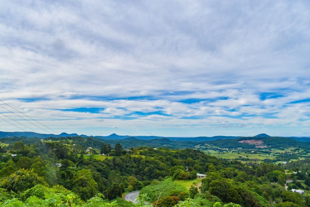 Overlooking A Lush Green Valley Under A Cloudy Sky — Superstretch300 Limousines In Sunshine Coast, QLD