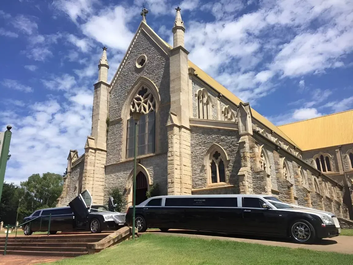 A Black Limousine is Parked in Front of a Church — Superstretch300 Limousines in Noosa, QLD