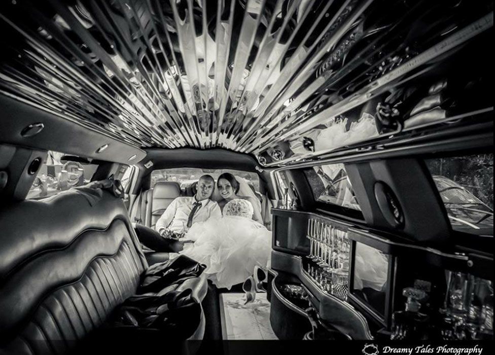 Black and White Photo of a Happy Wedding Couple Sitting in a Limousine — Superstretch300 Limousines in Sunshine Coast, QLD