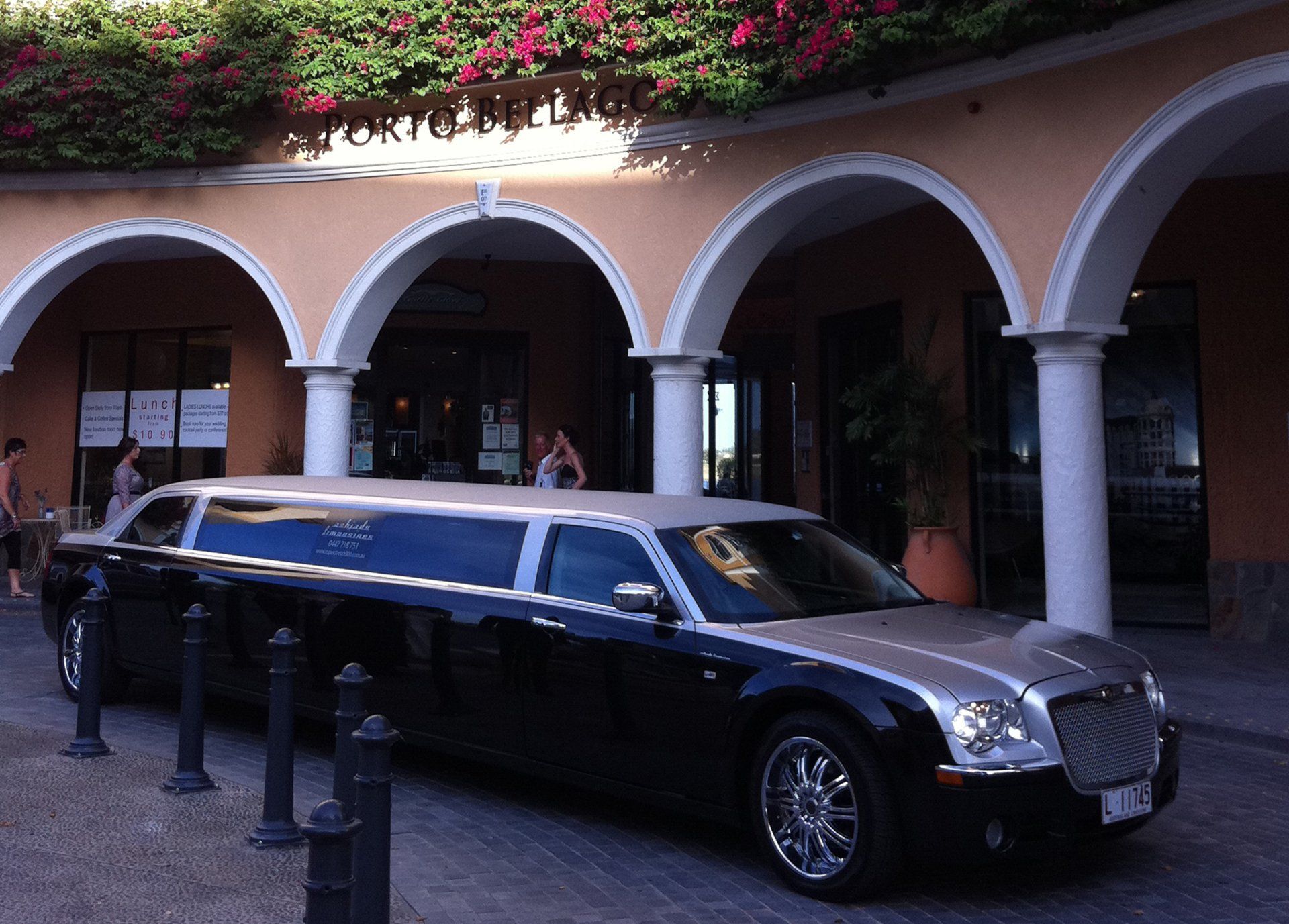 Black Limousine Parked in Front of an Arched Building Entrance — Superstretch300 Limousines in Mooloolaba, QLD